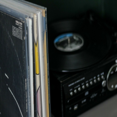 picture of vinyl records stacked on a shelf in their micron- poly outer sleeves to protect them front sleeves and covers from storage wear and help keep vinyl dust free